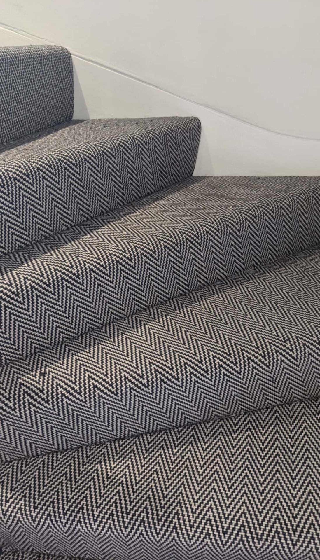 Herringbone stair runner fitted around winding steps
