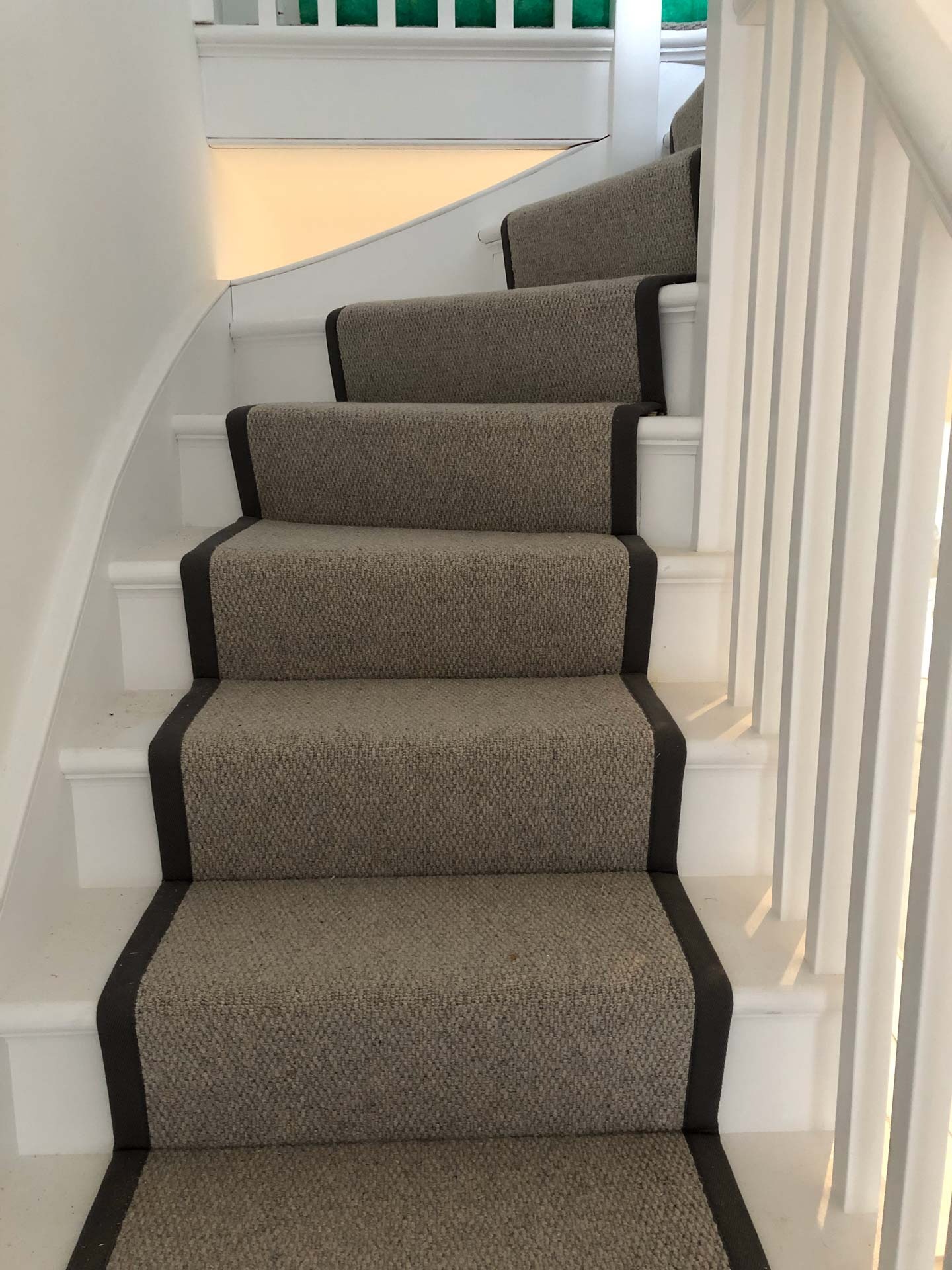 Neutral stair runner with a dark border