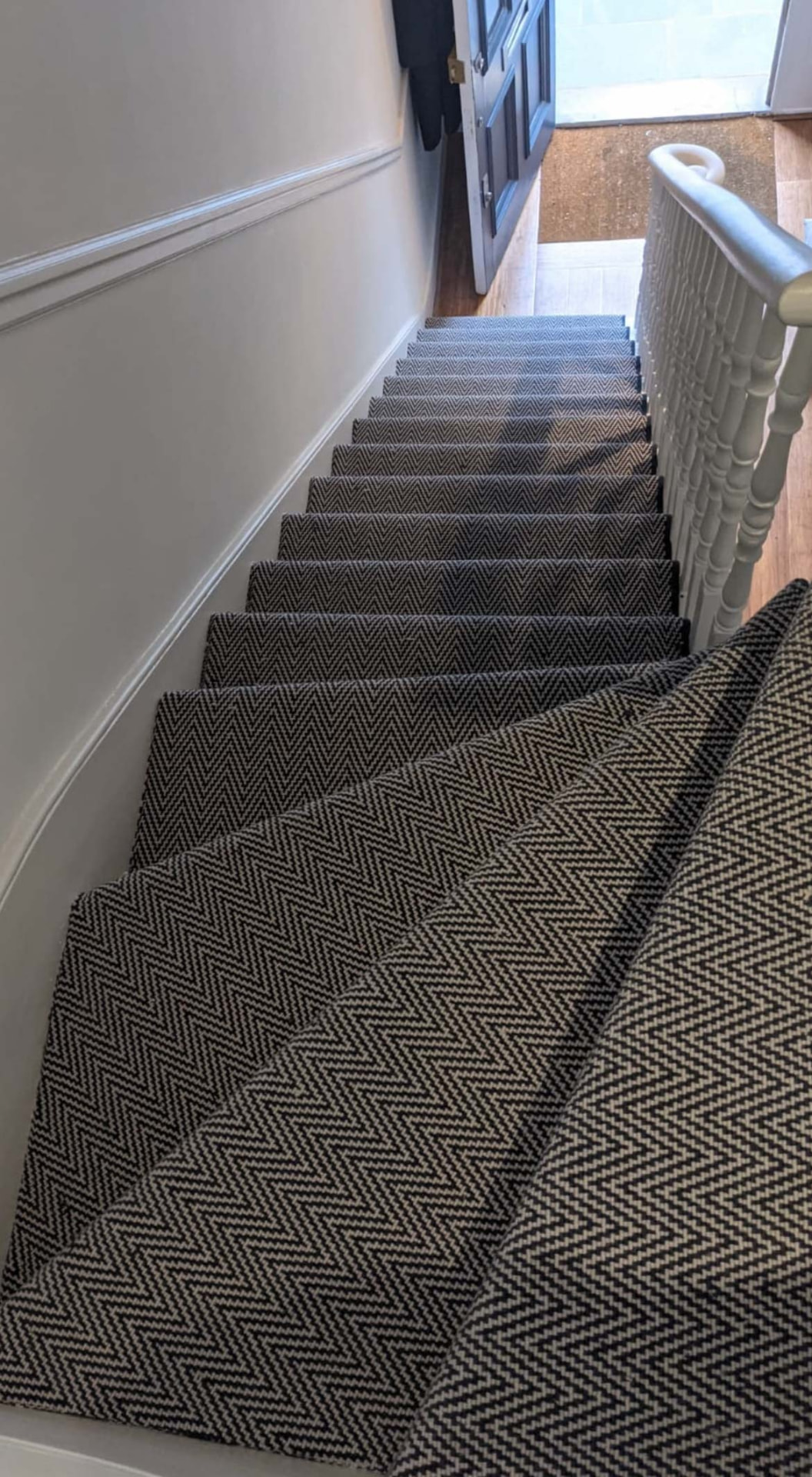 Herringbone stair runner fitted down a full staircase